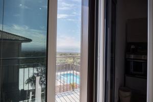 a view of a pool from a room with a window at Etna Exclusive in Ragalna