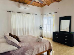 a bedroom with a bed and a dresser and a mirror at Paraiso Escondido in Lo de Marcos