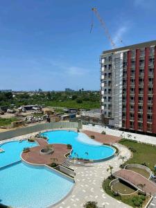 a large swimming pool in front of a building at Sabina's Condo @ Primeworld Lapu-Lapu Mactan in Lapu Lapu City
