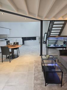 a living room with a table and a fish tank at Aqua Loft Suite exécutive & élégante Quartier Européen Bruxelles in Brussels