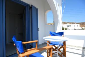 a table and two chairs on a porch with a table and chairs at Oneiro Rooms Kythnos in Kanala