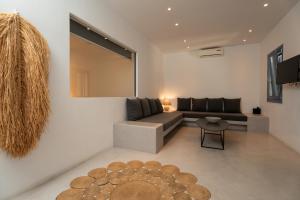 a living room with a couch and a table at Gianemma Luxury Apartments in Mylopotas