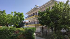 a building with balconies and trees in front of it at Villa Christina Sea Side B in Hanioti