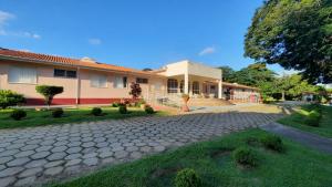 a house with a stone driveway in front of it at Eventos e Hospedagem São José in Sorocaba