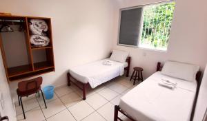 Postel nebo postele na pokoji v ubytování Eventos e Hospedagem São José
