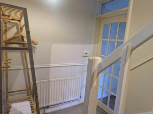a ladder in a room next to a door at Theatre Severn Town House, Parking & Quarry Views in Shrewsbury +39 photos