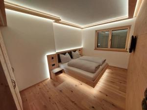 a small bedroom with a bed and a window at Dolomiten Home in Villnoss