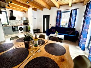 a living room with a wooden table and a couch at Domek wypoczynkowy z sauną i jacuzzi "ELDORADO" in Lubawka