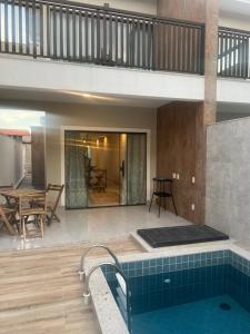 a pool in the middle of a house at Villa Darius in Cabo Frio