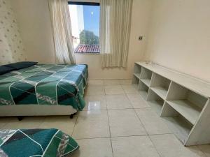 Letto o letti in una camera di O casarão rota da praia