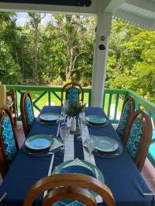 a table on a porch with a blue table cloth at Reefside Villa in Crown Point