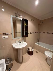 a bathroom with a sink and a toilet and a tub at Cuevas del Mar in Nueva de Llanes