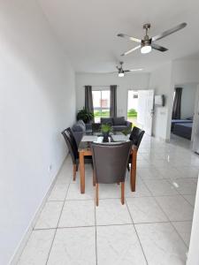 a dining room and living room with a table and chairs at Casa Perla in El Rosario