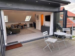 a living room and dining room with a table and chairs at Gorgeous modern countryside loft in Bath