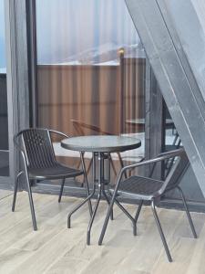 a table and two chairs on a balcony at Chopan Resort Aparan in Aparan