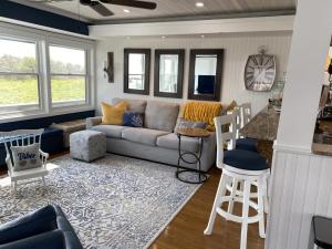 a living room with a couch and a table at 2 Bedroom 2 Bath Ocean Front Condo With Pool In Ship Bottom First Floor Unit in Ship Bottom