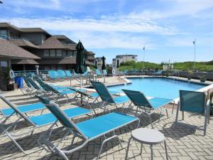 a group of lounge chairs and a swimming pool at 2 Bedroom 2 Bath Ocean Front Condo With Pool In Ship Bottom First Floor Unit in Ship Bottom