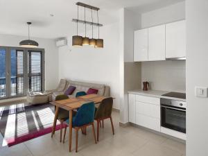 a kitchen and living room with a table and chairs at Lavander Bay E04 in Donji Morinj