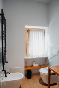 a bathroom with a sink and a toilet and a mirror at ILLASI DREAM ROOMS in Illasi