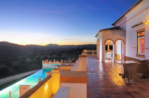 a villa with a swimming pool at sunset at Parque de Natureza de Noudar in Barrancos