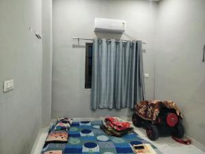 a room with a bed and a air conditioner at Annpurna Apartment in Varanasi