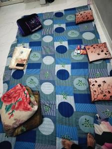 a blue and white floor with items on it at Annpurna Apartment in Varanasi