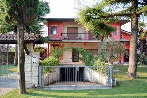a red house with a gate in front of it at B&B Silvia in Verona