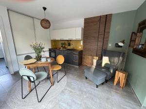 a kitchen and living room with a table and chairs at Apartament nad jeziorem in Barlinek