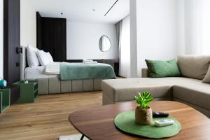a living room with a couch and a table at Erika's Boutique Hotel in Prishtinë