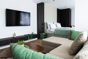 a living room with a couch and a bed at Erika's Boutique Hotel in Prishtinë