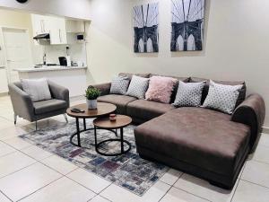 a living room with a couch and a table at Sweet Daisies Apartment in Mbabane