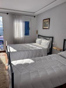 Postel nebo postele na pokoji v ubytování Hotel Al Manar