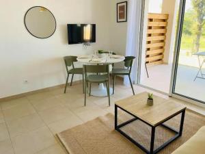 a dining room with a table and chairs and a mirror at T2 Waterfront Linguizzetta in Linguizzetta