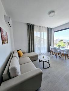 a living room with a couch and a table at Villa Virginia in Sarandë