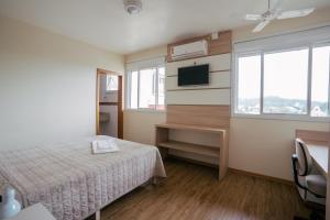 a hotel room with a bed and a television at Hotel Prata Villaggio in Nova Prata