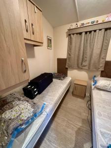 a small room with a bed and cabinets and a bed sidx sidx sidx at Logement vacances Yvoir avec piscine et deux chambres in Yvoir +20 photos