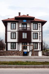 a large white and brown building on a street at Kayi Apart Hotel in Bolu