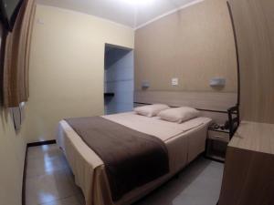 Tempat tidur dalam kamar di Hotel Brigadeiro