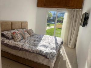 a bed sitting in a room with a window at Melrose beach apartment in Tamaris