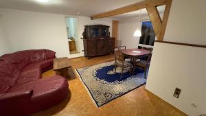 a living room with a couch and a table at Ferienwohnung Monteurzimmer Zülpich Bauernhof EH J in Zülpich