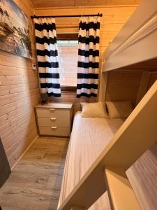 a small room with a bed and a window at Osada Lekranka in Kopań +42 photos