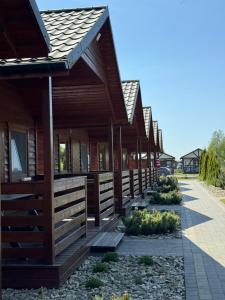 a wooden building with a row of windows at Osada Lekranka in Kopań +52 photos