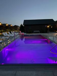 a swimming pool with purple lights on it at Osada Lekranka in Kopań