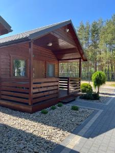 a wooden cabin with a pavilion in a park at Osada Lekranka in Kopań