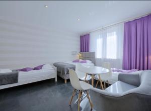 a room with three beds and a table and chairs at Willa Marion in Karpacz +76 photos