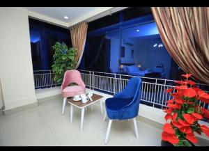 a balcony with two chairs and a table at Dreamers Hotel in Giza