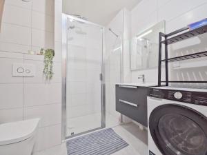 a bathroom with a shower and a washing machine at Incroyable T2 neuf et spacieux - Garage privé in L'Alpe-d'Huez +33 photos