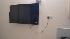 Un televisor de pantalla plana colgado en una pared en MJ homes, en Mtwapa