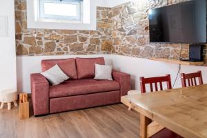 a living room with a couch and a table at Adega dos Avós - Casa completa in Alcobaça