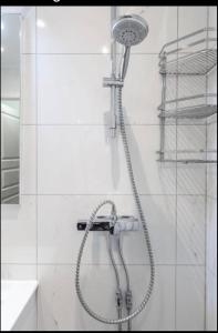 a shower with a shower head in a bathroom at Cozy room with beautiful nature in Husievägen 100-Malmo in Malmö